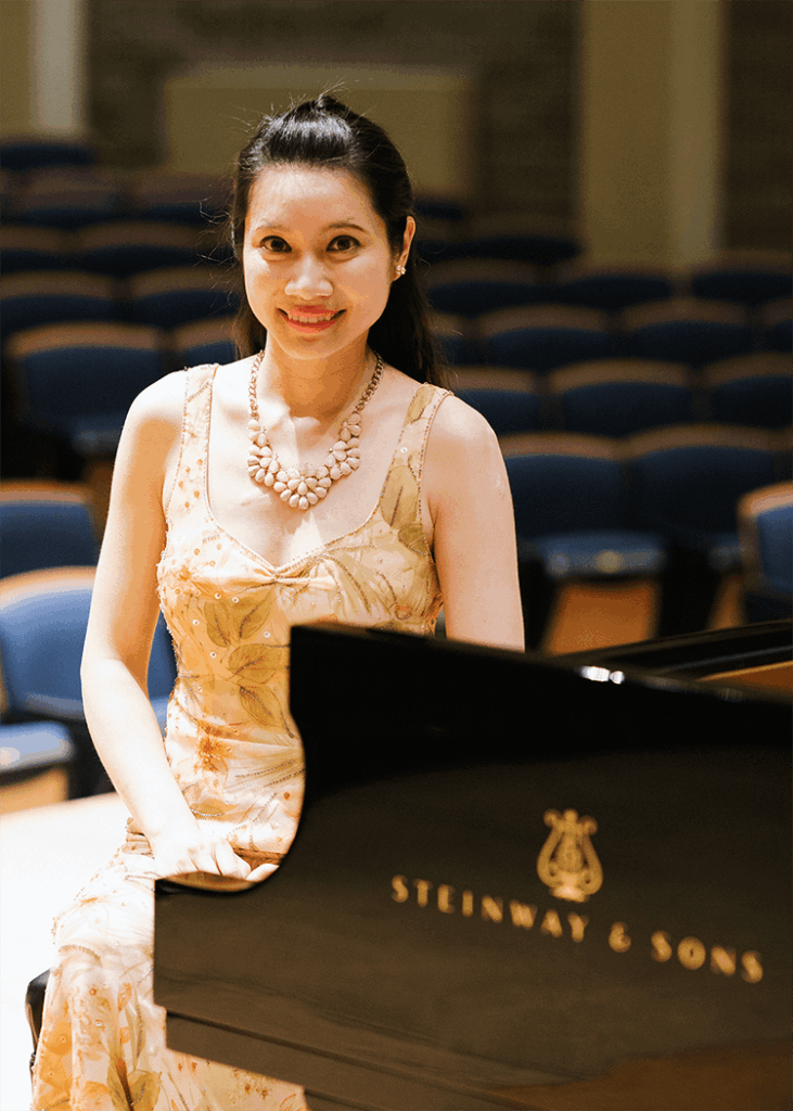 Soloist Mei-Hsuan Huang sitting at a piano